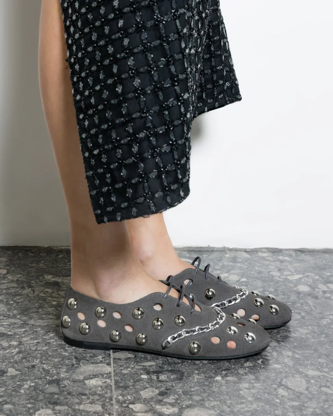 Gray flat shoe with studded details on a white background n- THUNA Kuwait - Saudi 