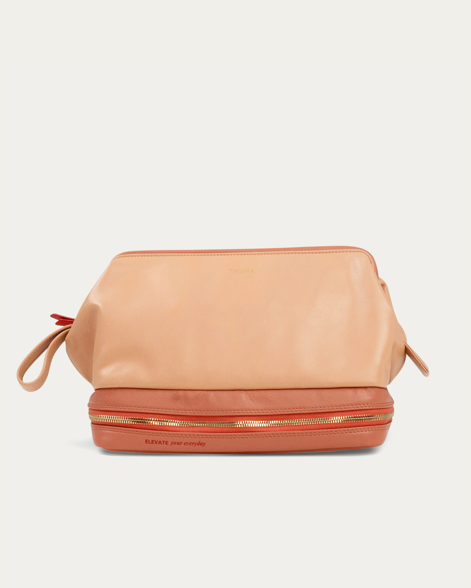 Beige makeup bag with gold zipper on a light gray background - Kuwait bags - KSA