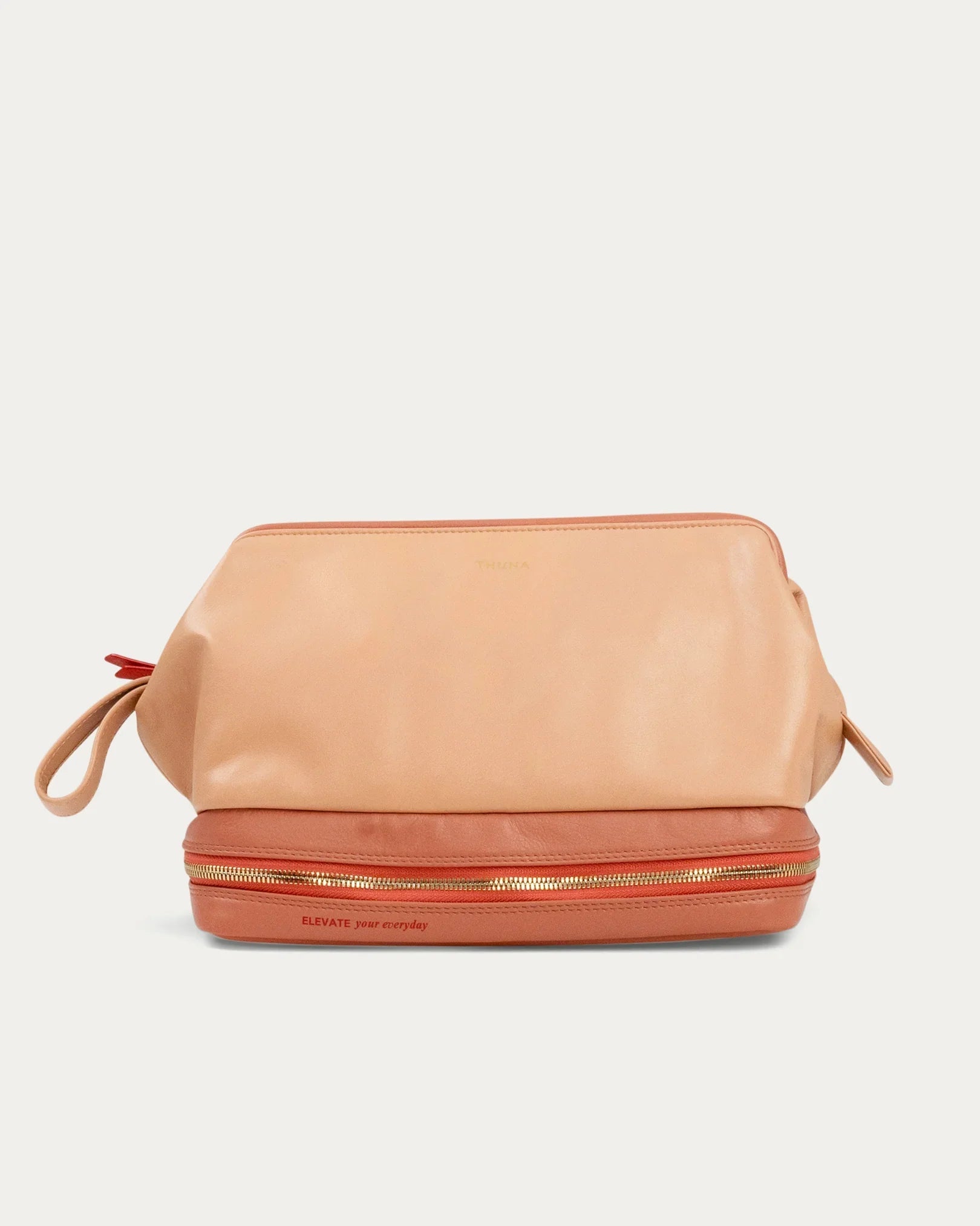 Beige makeup bag with gold zipper on a light gray background - Kuwait bags - KSA